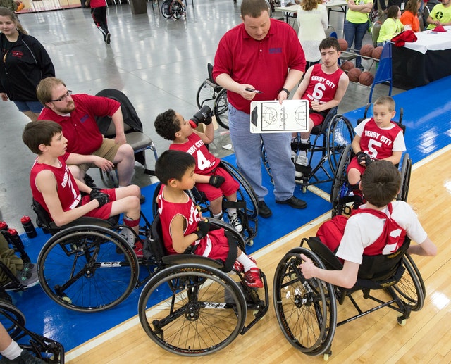 boys in a wheelchair playing basketball